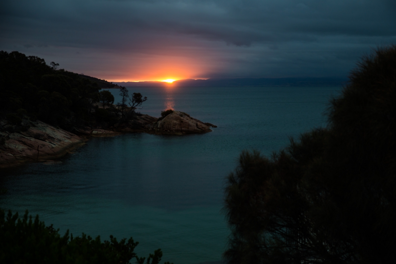 The sun sets at Honeymoon Bay in Freycinet National Park